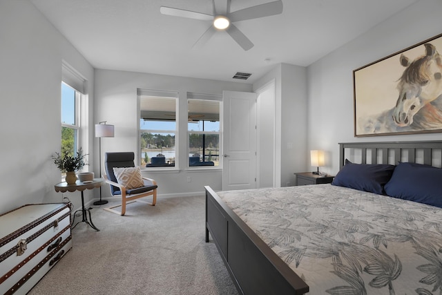 bedroom featuring visible vents, light carpet, multiple windows, and baseboards