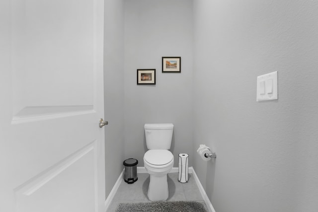 bathroom featuring toilet, tile patterned flooring, and baseboards