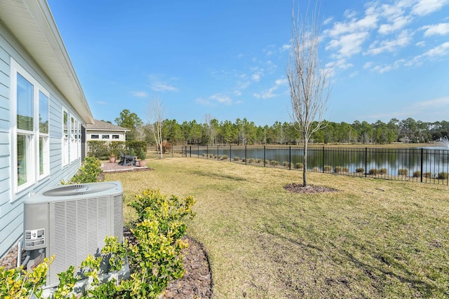 view of yard with cooling unit, a patio area, a water view, and a fenced backyard