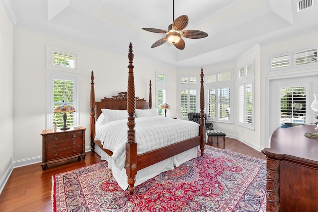 248 Marshside Dr, Saint Augustine, FL 32080 - bedroom with a tray ceiling, multiple windows, wood finished floors, and ornamental molding