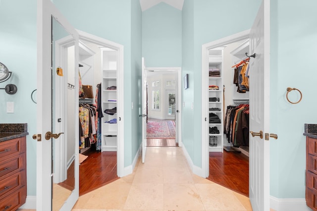 248 Marshside Dr, Saint Augustine, FL 32080 - hallway featuring high vaulted ceiling, baseboards, and light wood-type flooring