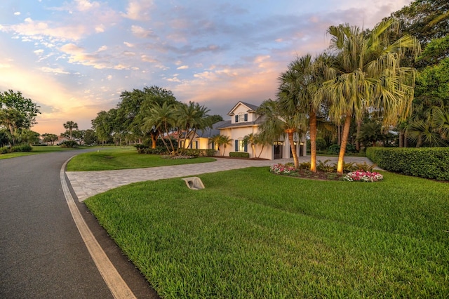 248 Marshside Dr, Saint Augustine, FL 32080 - view of front of house featuring curved driveway, a front yard, and stucco siding