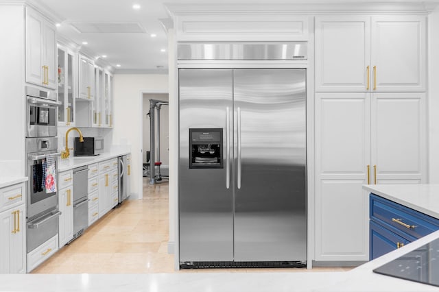 248 Marshside Dr, Saint Augustine, FL 32080 - kitchen with stainless steel appliances, a warming drawer, beverage cooler, white cabinetry, and glass insert cabinets