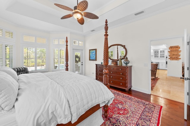 248 Marshside Dr, Saint Augustine, FL 32080 - bedroom featuring a tray ceiling, wood finished floors, ornamental molding, baseboards, and ceiling fan