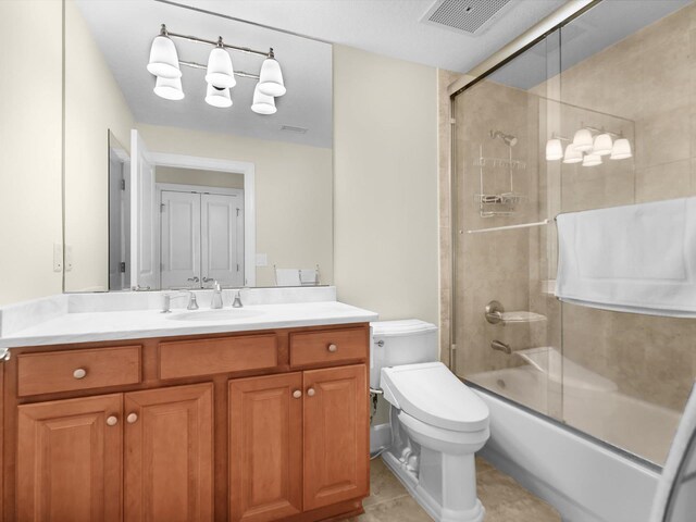 bathroom featuring enclosed tub / shower combo, toilet, vanity, visible vents, and tile patterned floors