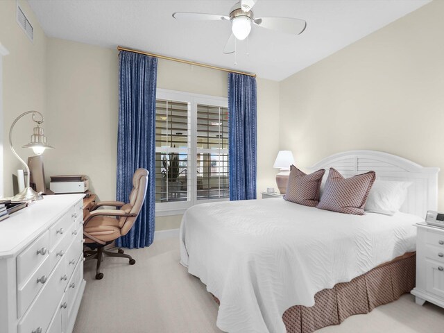 bedroom featuring light colored carpet, visible vents, ceiling fan, and baseboards