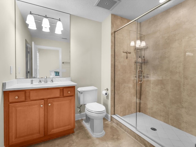 bathroom featuring toilet, vanity, a shower stall, and visible vents