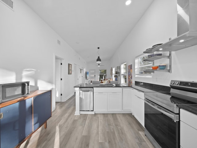 kitchen featuring extractor fan, appliances with stainless steel finishes, sink, white cabinets, and light hardwood / wood-style flooring