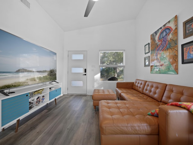 living room featuring dark hardwood / wood-style flooring, lofted ceiling, and ceiling fan