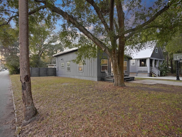 view of front facade featuring board and batten siding and fence