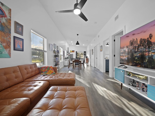 living room featuring ceiling fan, high vaulted ceiling, and hardwood / wood-style floors