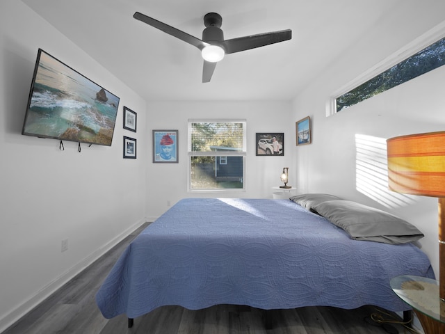 bedroom with ceiling fan and dark hardwood / wood-style flooring