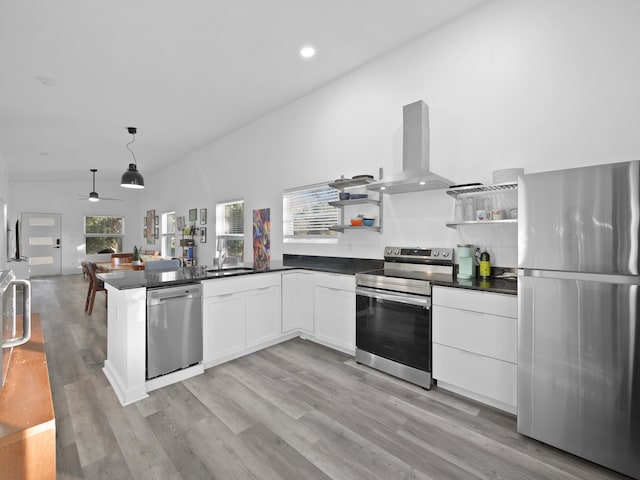 kitchen featuring sink, white cabinetry, hanging light fixtures, stainless steel appliances, and island range hood