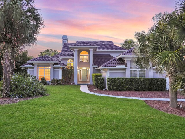 306 Marsh Point Cir, Saint Augustine, FL 32080 - view of front of home featuring a chimney, a yard, and stucco siding