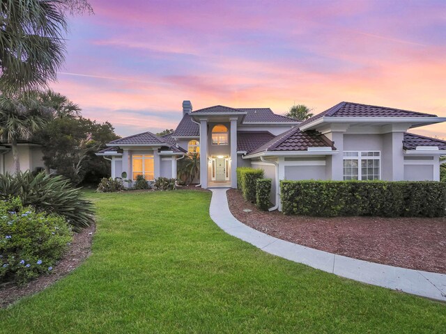 306 Marsh Point Cir, Saint Augustine, FL 32080 - view of front of home featuring a front lawn, stucco siding, and a tiled roof