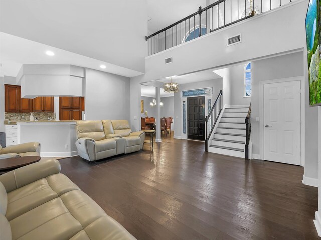 306 Marsh Point Cir, Saint Augustine, FL 32080 - living room featuring a chandelier, stairs, dark wood-style floors, a towering ceiling, and recessed lighting