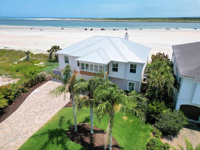 drone / aerial view featuring a water view and a beach view