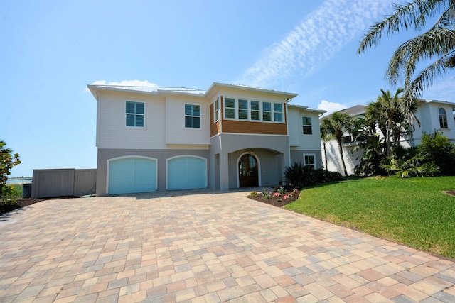 view of front of home featuring a garage and a front lawn