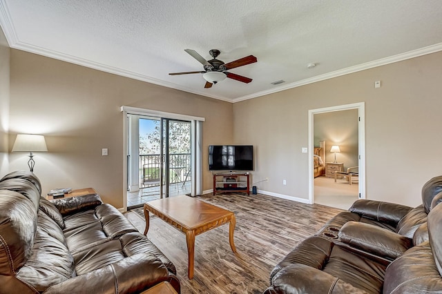112 Laurel Wood Way Unit 202, Saint Augustine, FL 32086 - living room featuring ceiling fan, wood finished floors, ornamental molding, baseboards, and a textured ceiling