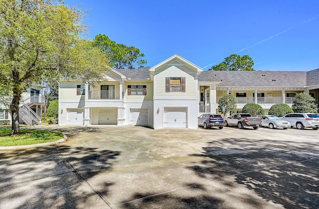 112 Laurel Wood Way Unit 202, Saint Augustine, FL 32086 - townhome / multi-family property featuring a garage, stucco siding, and driveway