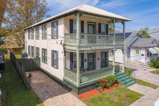 view of front of home with covered porch and a balcony