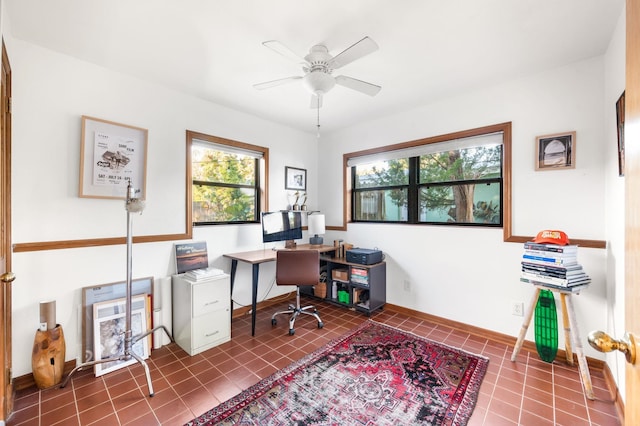 tiled office space featuring a healthy amount of sunlight, baseboards, and ceiling fan