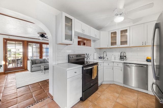 kitchen with a sink, ceiling fan, light countertops, appliances with stainless steel finishes, and tasteful backsplash