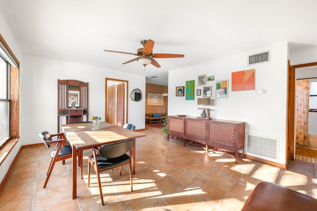 dining area with visible vents, baseboards, and a ceiling fan