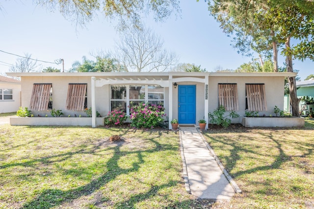 view of front of house featuring stucco siding and a front yard