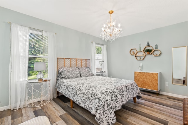 bedroom featuring hardwood / wood-style flooring and a notable chandelier