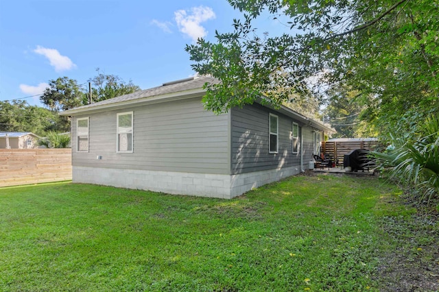 view of side of home featuring a yard