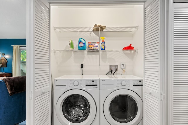 clothes washing area featuring washer and dryer