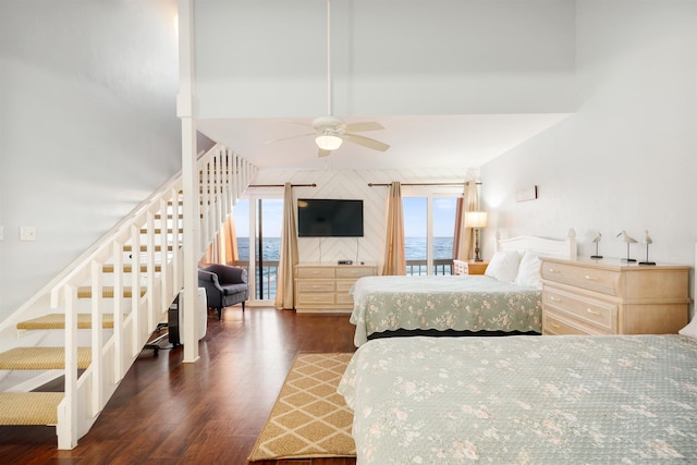 bedroom featuring ceiling fan, dark wood-type flooring, and multiple windows