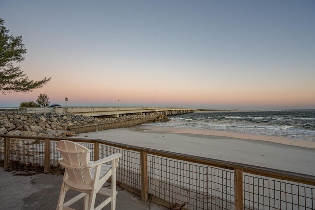 exterior space featuring a beach view and a water view