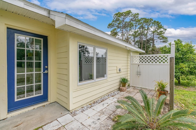 view of home's exterior with fence and a patio