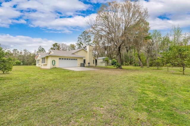 view of yard with driveway and an attached garage