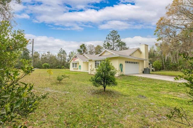 ranch-style house with driveway, a chimney, an attached garage, a front lawn, and central AC