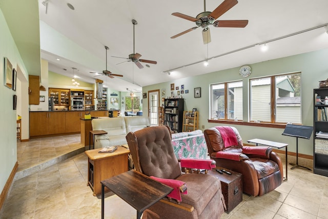 living room featuring vaulted ceiling, light tile patterned floors, baseboards, and track lighting