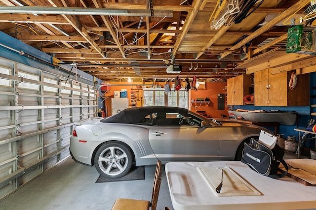 garage featuring a garage door opener and electric panel