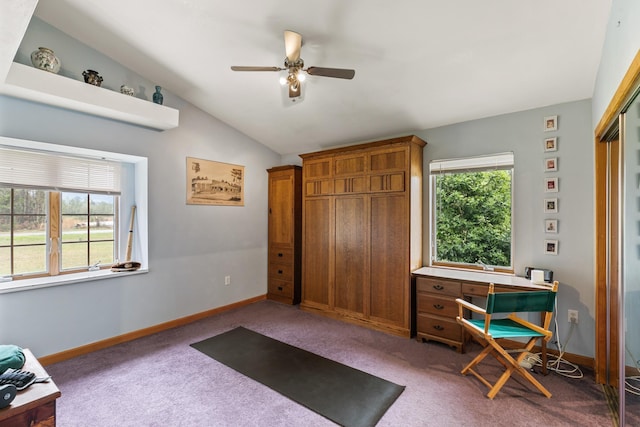 carpeted office featuring plenty of natural light, baseboards, vaulted ceiling, and a ceiling fan