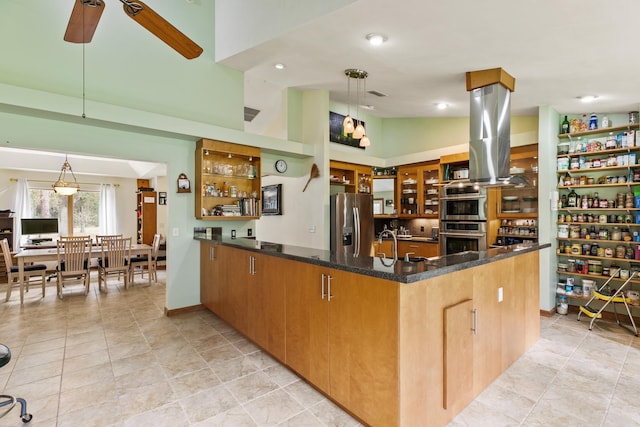 kitchen with a peninsula, vaulted ceiling, appliances with stainless steel finishes, dark stone counters, and glass insert cabinets