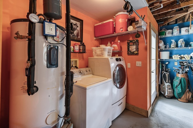 clothes washing area featuring water heater, laundry area, and separate washer and dryer