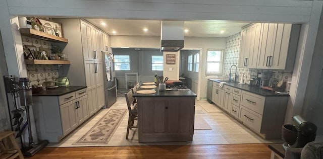 4208 Vermont Blvd, Elkton, FL 32033 - kitchen featuring dark countertops, backsplash, open shelves, and stainless steel appliances