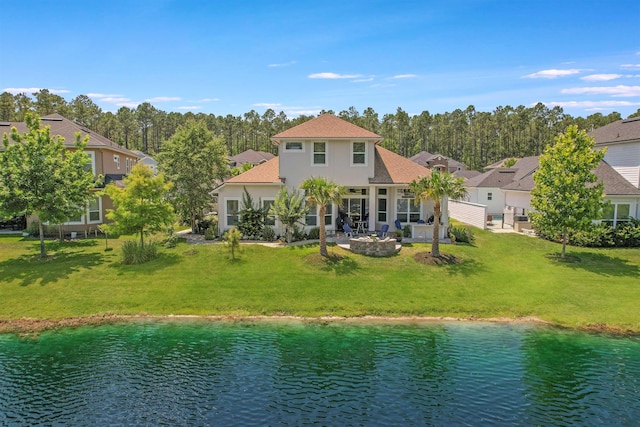 100 Coppinger Pl, Saint Johns, FL 32259 - back of house with a yard, a water view, stucco siding, and an outdoor fire pit