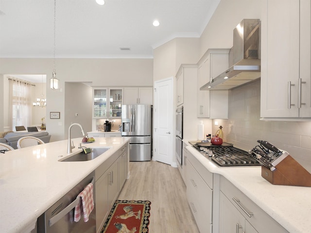 100 Coppinger Pl, Saint Johns, FL 32259 - kitchen featuring stainless steel appliances, wall chimney exhaust hood, crown molding, glass insert cabinets, and backsplash
