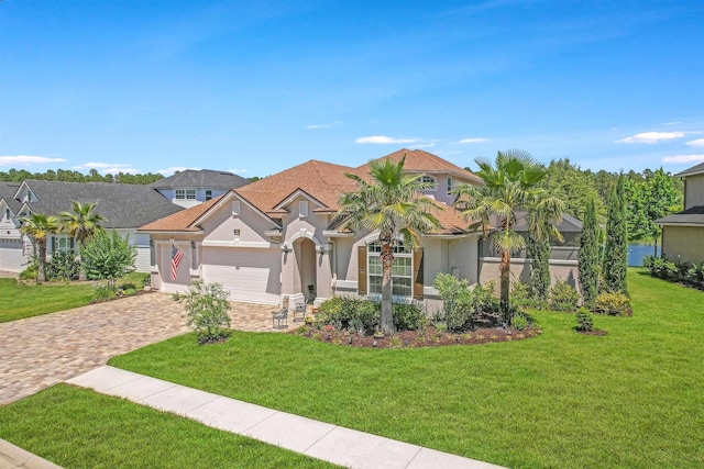 100 Coppinger Pl, Saint Johns, FL 32259 - mediterranean / spanish-style home with stucco siding, decorative driveway, a front lawn, and an attached garage