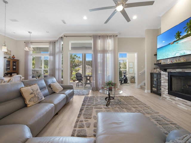 100 Coppinger Pl, Saint Johns, FL 32259 - living area featuring a ceiling fan, wood finished floors, a glass covered fireplace, recessed lighting, and crown molding