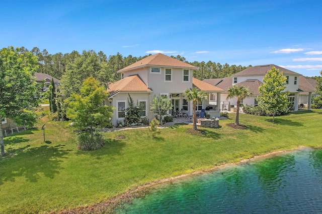 100 Coppinger Pl, Saint Johns, FL 32259 - rear view of property with a yard, a patio area, stucco siding, a water view, and an outdoor fire pit