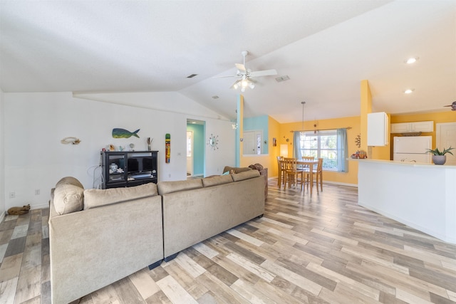 living room with light wood-type flooring, lofted ceiling, and ceiling fan