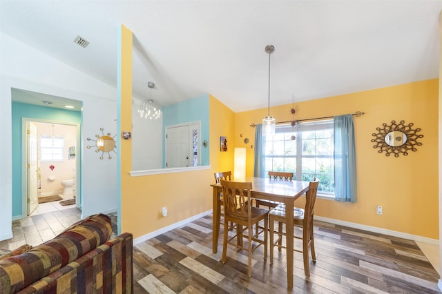 dining area with lofted ceiling and dark hardwood / wood-style flooring